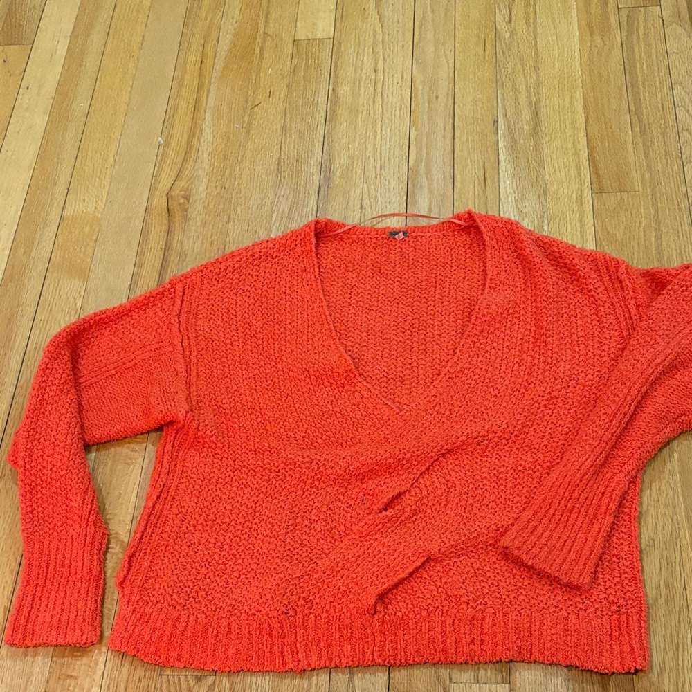 Free People V neck sweater twist design in the front.